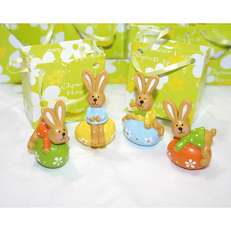 Rabbit syntheticresin lying on egg in lacquer bag